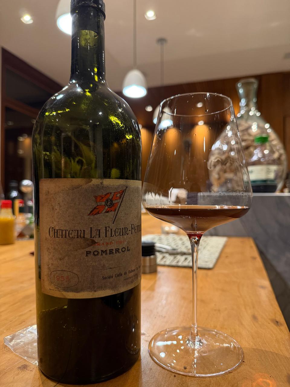 An opened magnum of Château La Fleur-Pétrus 1955 beside the wine in a glass